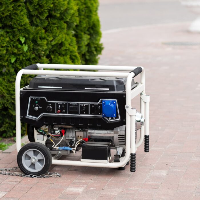 a white generator with wheels on it on a back porch