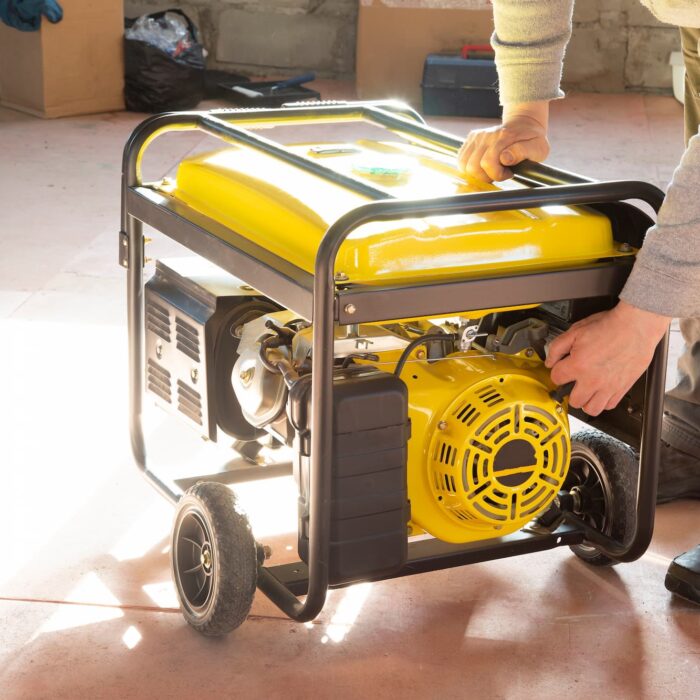 a yellow power generator on wheels in a backyard