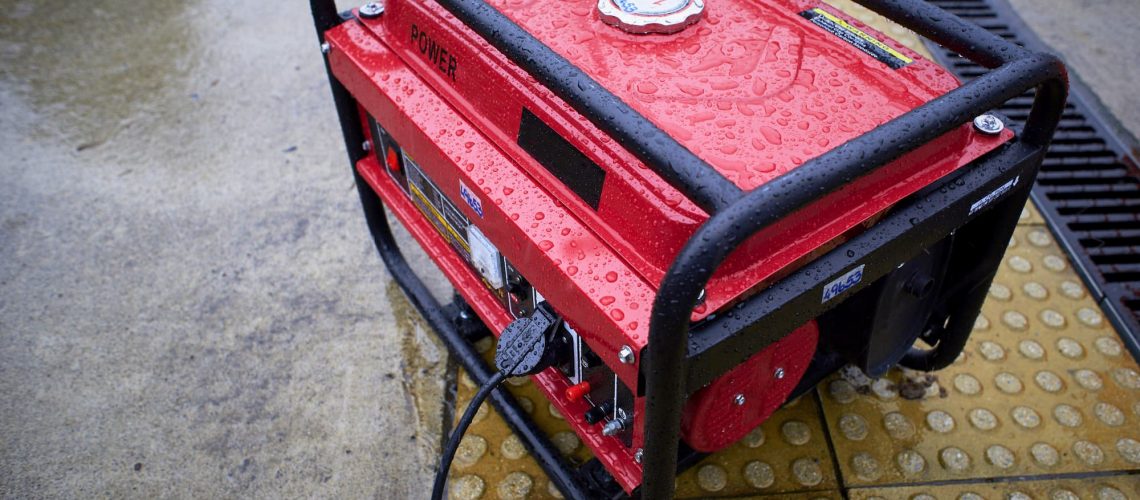 red generator in the rain on the sidewalk